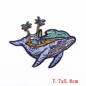 Macro detail of whale camping embroidery patch with precise stitching and dimensions