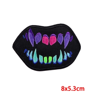 Detailed high-density punk monster mouth embroidered patch with vibrant purple and green thread