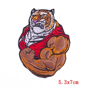 Detailed close-up of tiger head embroidery patch with muscular arms for DIY clothing