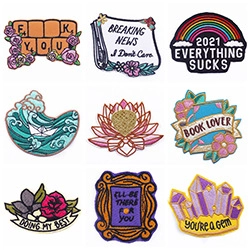 Detailed macro view of nine unique embroidered patches with slogans and nature motifs