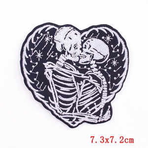 Punk heart-shaped embroidered patch featuring kissing skeletons and star constellations