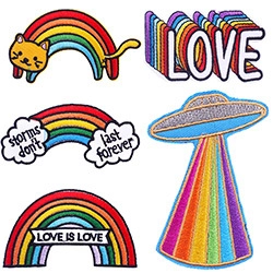 Detailed embroidery texture of rainbow cat and UFO iron-on patches with vivid stitching