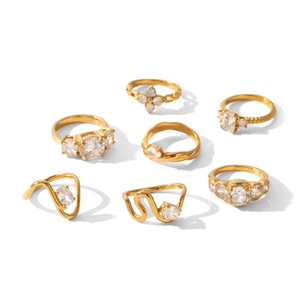 Close-up view of multiple gold-plated stainless steel rings with zircon stones