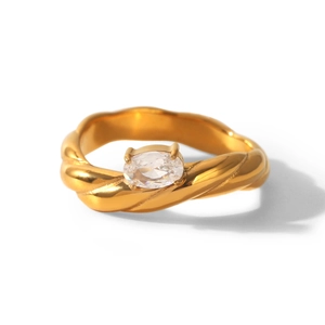 Macro view of gold-plated stainless steel twist ring with an oval zircon center stone