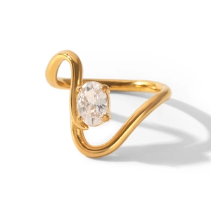 Close-up of a gold-plated stainless steel ring with an oval zircon in a curve design