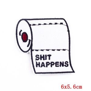 Macro detail of Shit Happens embroidered toilet paper patch with red stitching 6x5.6cm