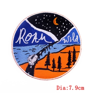 Round Roam Wild embroidered patch featuring a camping van and starry night sky, 7.9cm