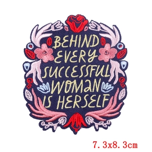Floral embroidered letter patch with inspirational gold quote on navy twill fabric