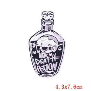 Macro detail of Death Potion skull embroidery patch with black and white gothic design