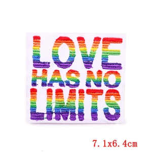 Detail of embroidered patch showing rainbow text Love Has No Limits on white twill