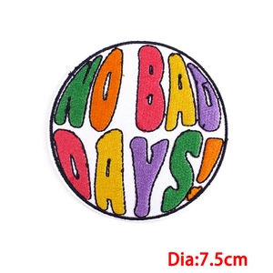 Close-up of circular NO BAD DAYS! embroidered patch with rainbow letters and 7.5cm diameter
