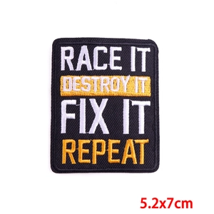 Macro view showing embroidery details of a rectangular patch with motivational text