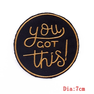7cm round embroidered patch with You Got This slogan in gold stitching on black fabric
