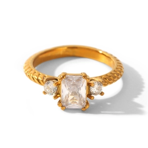 Close-up of an elegant gold twisted band ring with a large rectangular clear zircon stone