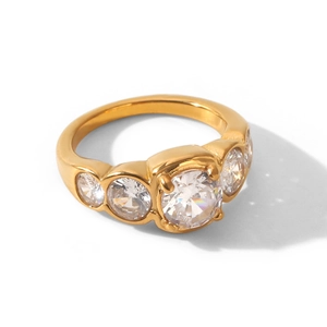 Close-up of elegant gold stainless steel ring with five sparkling round cubic zirconias.