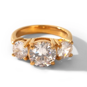 Close-up detail of a gold-plated stainless steel ring with three sparkling round zircons.