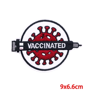 Detail of embroidered patch showing a vaccine syringe and vaccinated text, 9x6.6cm