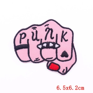 Close-up of pink punk fist embroidery patch with PUNK lettering and black heart tattoo