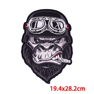 Macro view of gorilla punk embroidery patch with biker helmet and cigar details