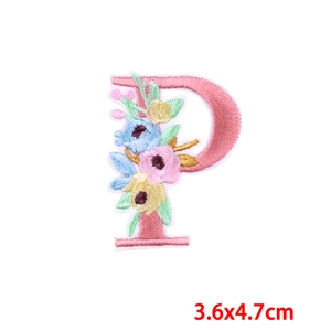 Close-up of letter P floral embroidery patch with pink border and colorful blossoms