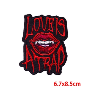 Detailed embroidery of flaming rose skull and lips patch measuring 6.7x8.5cm