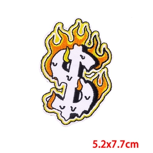 Macro shot of 5.2x7.7cm dollar sign embroidery patch with flame design for DIY clothing