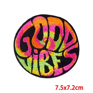 Detailed view of Good Vibes embroidered patch with colorful gradient letters and size label