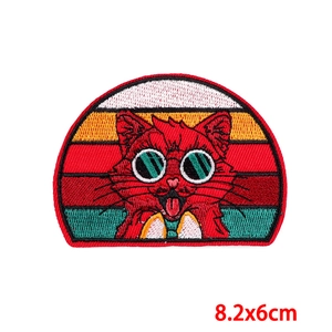 Detail view of cartoon red cat embroidery patch with sunset stripes measuring 8.2x6cm