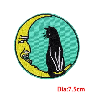 Detail of a 7.5cm round embroidered patch featuring a moon and cat with clear stitching