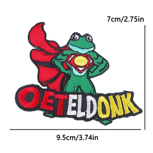 Detailed embroidery of a green frog patch with a red cape and Oeteldonk text