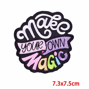Embroidered 'MAKE YOUR OWN MAGIC' patch for clothing, colorful letters on black base