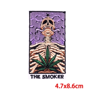 Tarot style skeleton embroidery patch with The Smoker text and hemp leaf design