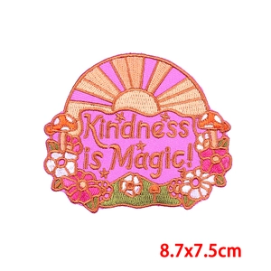 Detailed texture of Kindness is Magic mushroom embroidery patch with floral accents