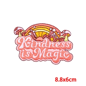 Macro view of kindness is magic embroidery patch with rainbow and mushroom details