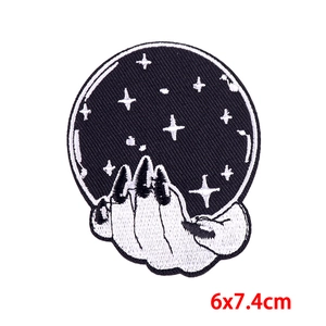 Close-up of gothic embroidery patch featuring a mystical crystal ball with stars, 6x7.4cm