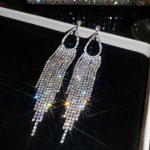 Close-up detail of exquisite sparkling rhinestone fringe drop earrings in silver finish