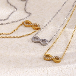Close-up of 18K gold plated stainless steel infinity necklaces with sparkling rhinestones