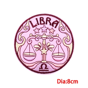 Detailed embroidery of Libra zodiac patch featuring pink fabric and 8cm diameter