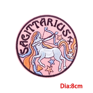 Detail of 8cm Sagittarius embroidery patch with fine pink textures and stars