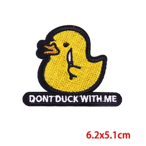 Close-up of yellow duck embroidery patch with knife and Don't Duck With Me text