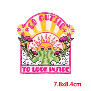 Detailed embroidery patch with sunrise mountain design and motivational slogan