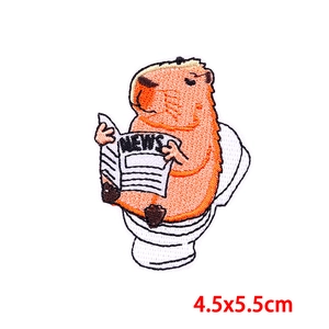 Macro view of cartoon capybara on toilet embroidery patch, size 4.5x5.5cm for DIY decor