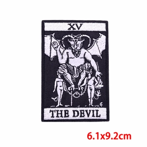 Detailed embroidery of The Devil XV tarot card patch with black and white thread texture