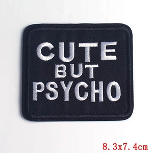 Detail of Cute But Psycho embroidered patch showing black fabric texture and 8.3x7.4cm size