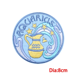 Detail of an 8cm Aquarius zodiac embroidered patch featuring blue and gold thread patterns
