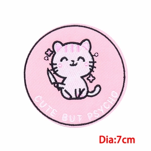 Macro detail of round Pink Cat embroidered patch with CUTE BUT PSYCHO text and 7cm diameter