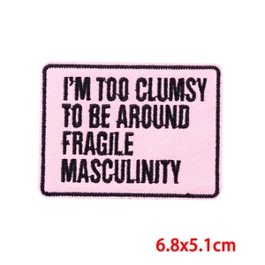 Pink rectangular embroidery patch with black embroidered slogan and stitched border