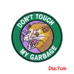 Detailed embroidery of an opossum patch with Don't Touch My Garbage text on 7cm badge