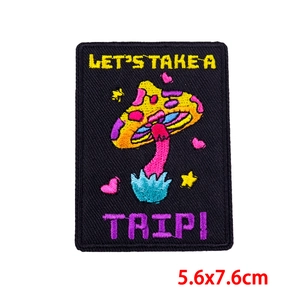 Detail of colorful mushroom tarot embroidery patch with Let's Take A Trip text