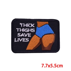 Macro detail of Thick Thighs Save Lives embroidered patch measuring 7.7x5.5cm